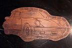 Wooden car-shaped cribbage board with '1988' on a dark surface