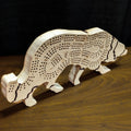Wooden dog-shaped cribbage board on a wooden surface with a dark background