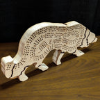 Wooden dog-shaped cribbage board on a wooden surface with a dark background