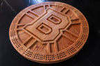 Wooden cribbage board with Bruins symbol on a dark surface