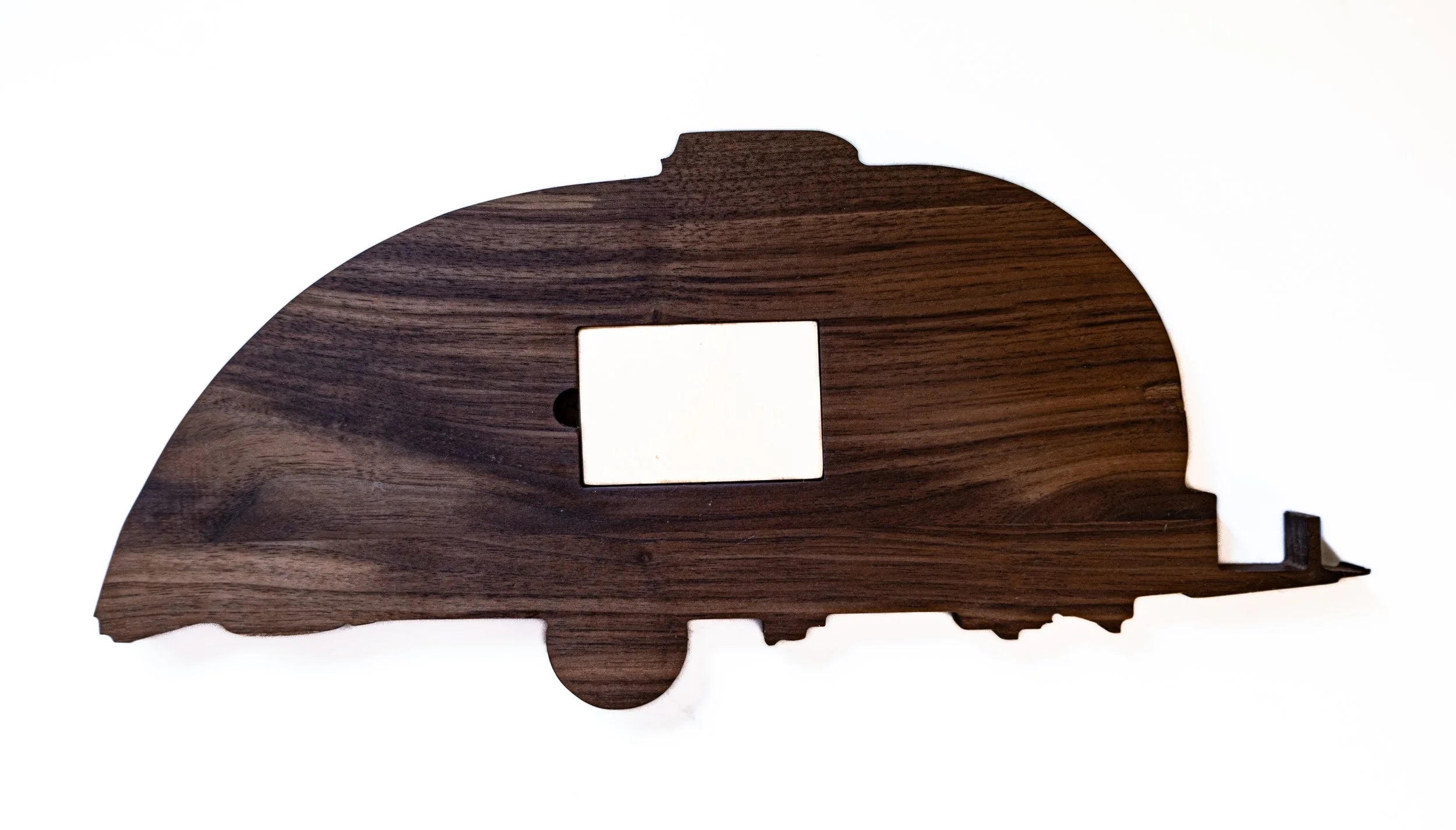 Wooden cutout of a camper on a white background