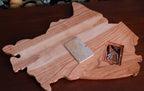 Back view of a Canada shaped cribbage board with metal pegs.