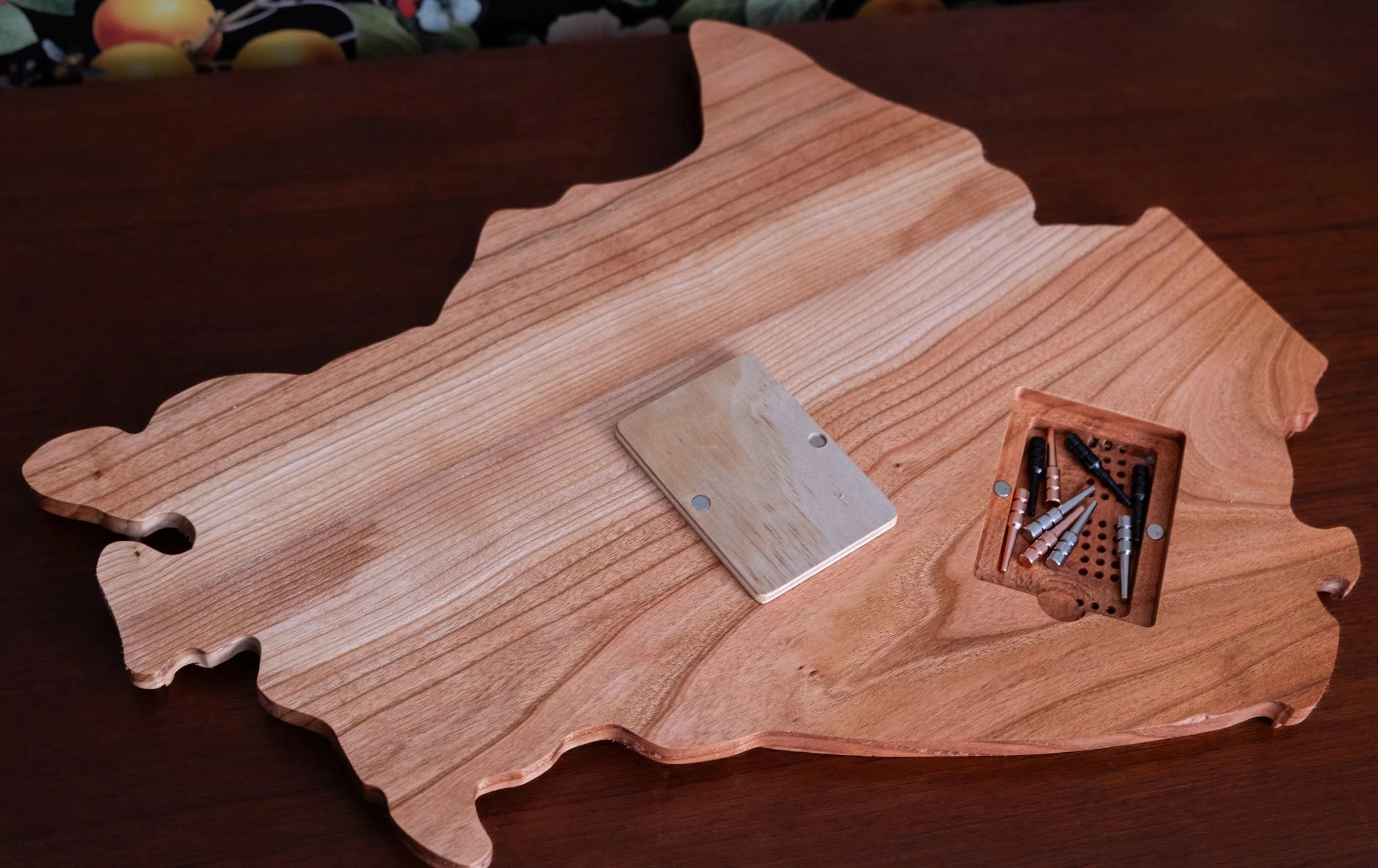 Back view of a Canada shaped cribbage board with metal pegs.