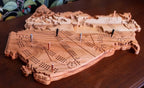 Wooden cribbage board shaped like a ship on a wooden surface