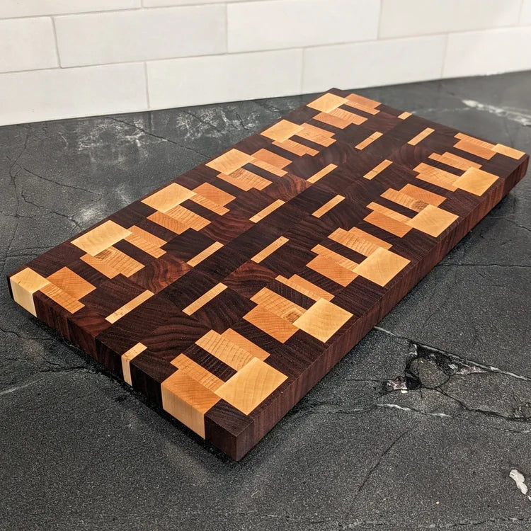 Wooden cutting board with geometric pattern on a dark surface