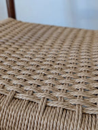 Close-up of a woven chair seat with a blurred background