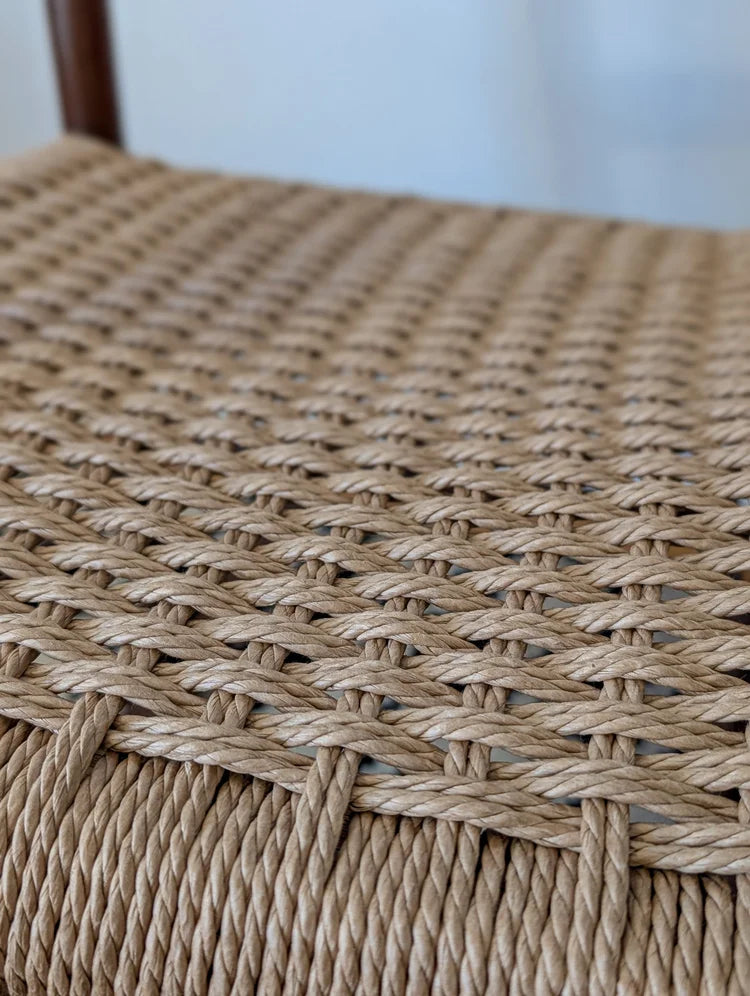 Close-up of a woven chair seat with a blurred background