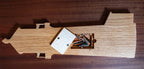 Wooden lighthouse-shaped cribbage board on a wooden surface