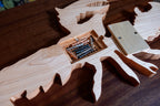 Wooden lobster-shaped cribbage board on a wooden surface