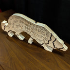 Wooden dog-shaped cribbage board on a wooden surface with a dark background