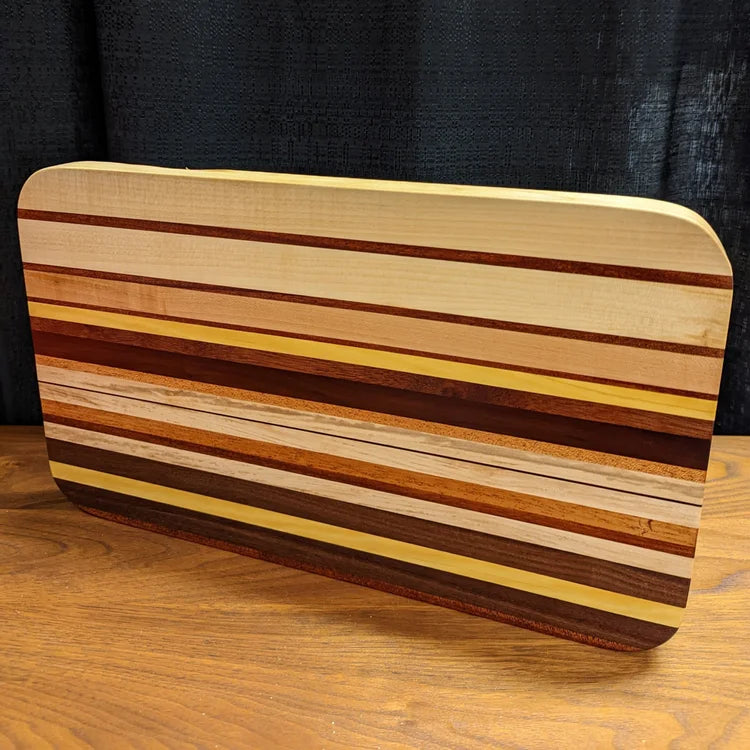Wooden cutting board with striped pattern on a wooden surface