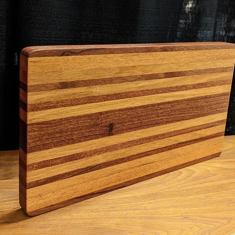 Wooden cutting board with a striped pattern on a wooden surface