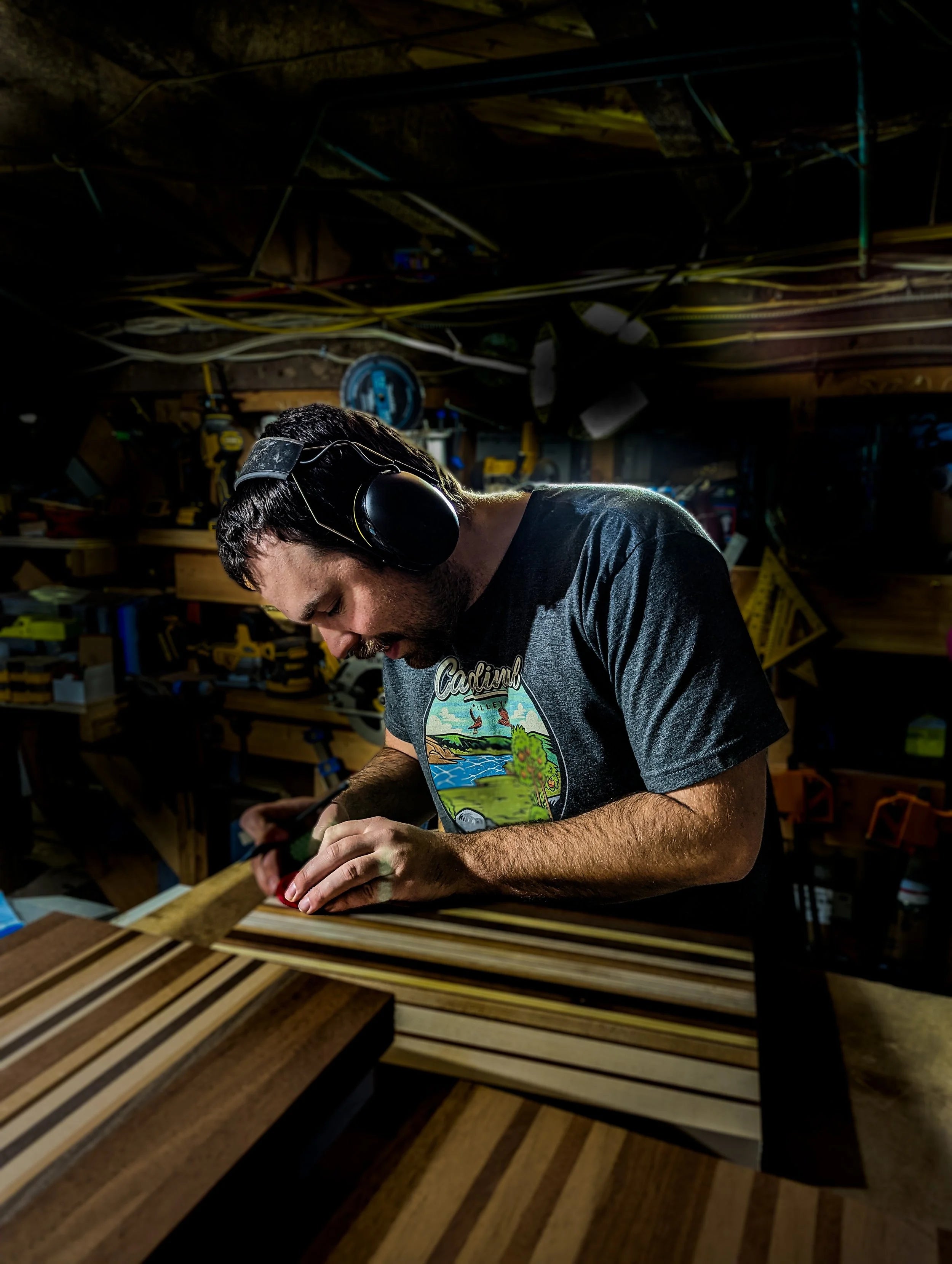Man working on a wooden cutting board in a workshop