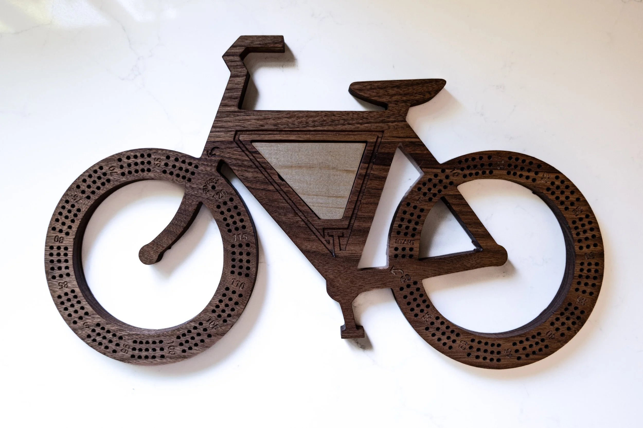 Wooden bicycle wall art on a white background