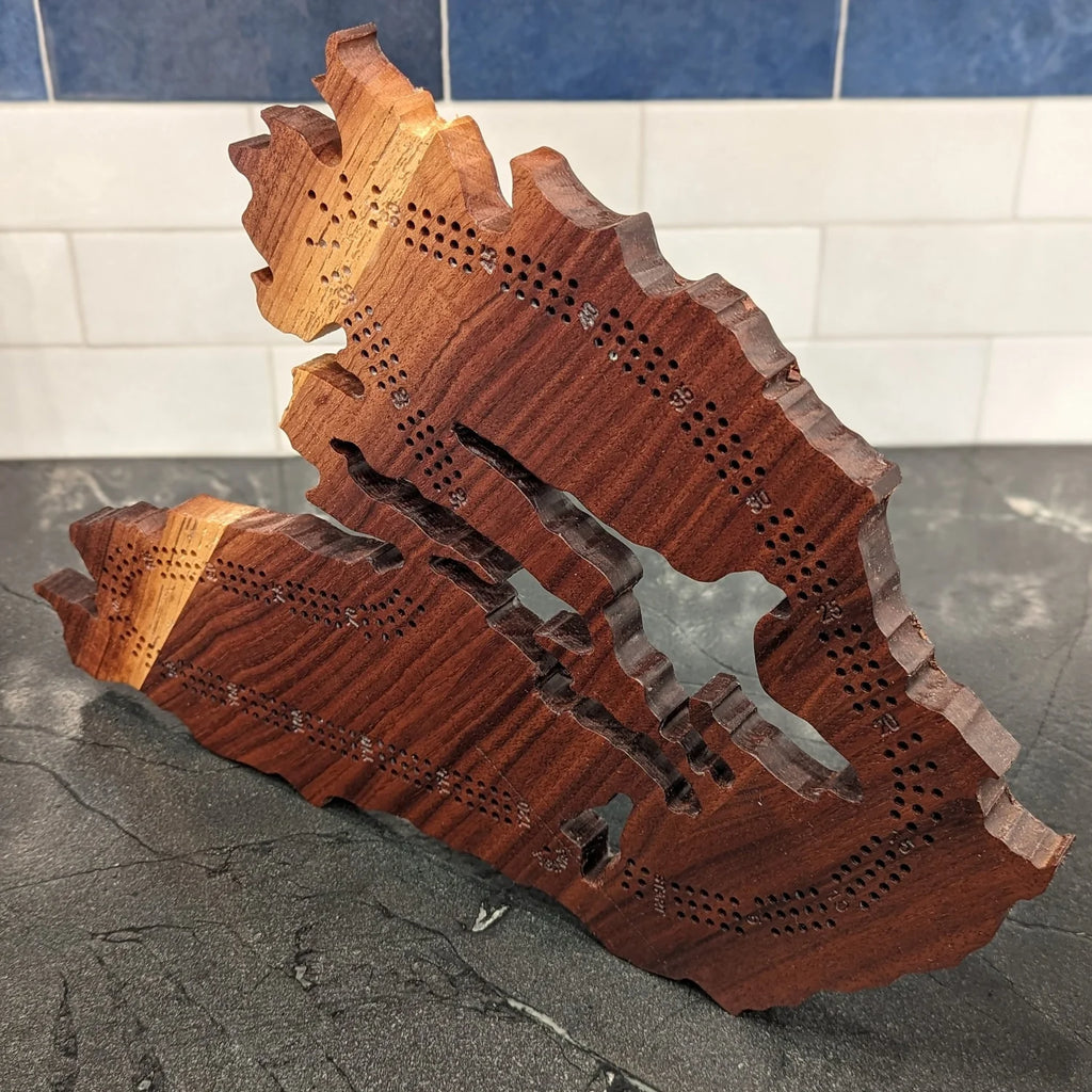 Wooden cribbage board in the shape of Cape Breton, Nova Scotia.
